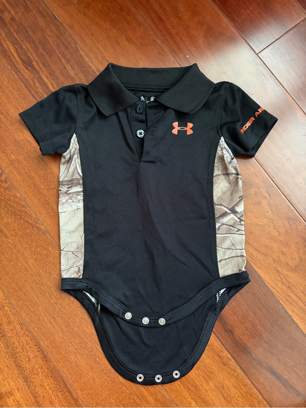 Under Armour Black Dryfit Polo Snap Bodysuit with Orange Logo and Camo Sides